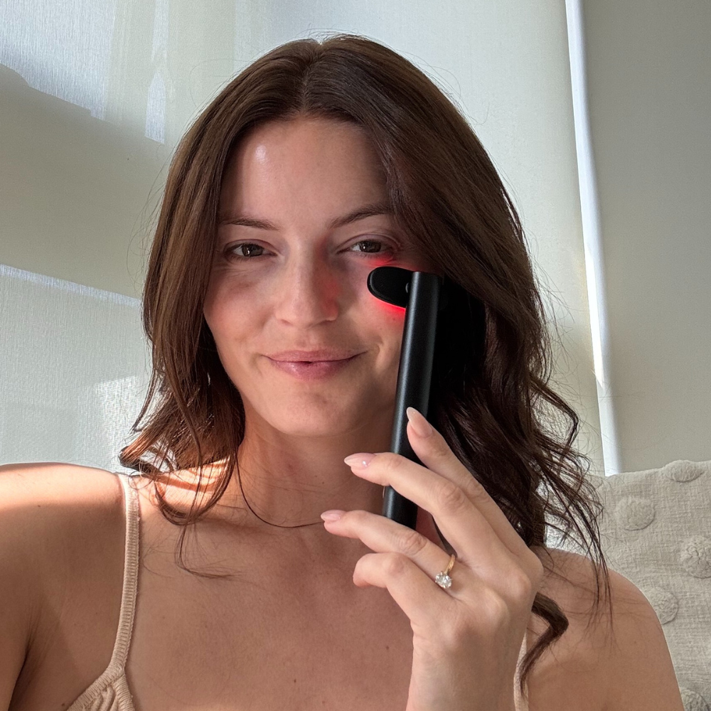 Woman using Liorae Beauty Wand Red Light facial therapy wand