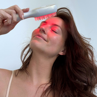 Woman using Nano Comb on scalp